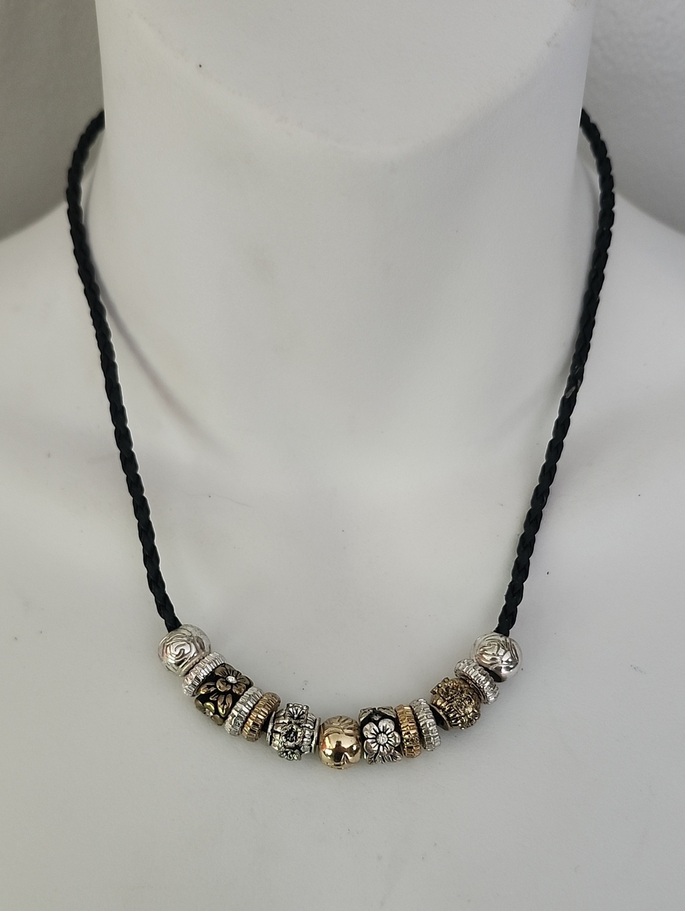 Black Braided Cord Necklace with Silver and Gold Tone Floral & Textured Beads